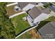 Aerial view of a backyard with a privacy fence, patio, and a well-manicured lawn at 7113 Amberly Hills Rd, Charlotte, NC 28215