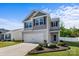Inviting two-story home with a two-car garage, beautifully landscaped front yard and appealing curb appeal under a sunny sky at 7113 Amberly Hills Rd, Charlotte, NC 28215