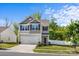Charming two-story home boasts a landscaped yard, attached garage, and neutral-tone siding beneath a clear blue sky at 7113 Amberly Hills Rd, Charlotte, NC 28215