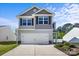 Welcoming exterior of a two-story house featuring a two-car garage, neat landscaping, and classic architectural details at 7113 Amberly Hills Rd, Charlotte, NC 28215