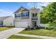 Attractive exterior view of a well-maintained two-story home showcasing a manicured lawn and attached two-car garage at 7113 Amberly Hills Rd, Charlotte, NC 28215