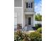 Up-close of home's entry, highlighting manicured landscaping leading to the front door with decorative stone accents at 7113 Amberly Hills Rd, Charlotte, NC 28215