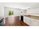 Bright kitchen boasts granite counters, stainless steel sink, and wood-look flooring at 7113 Amberly Hills Rd, Charlotte, NC 28215