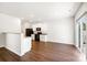 Bright kitchen features white cabinets, granite counters, black appliances, and wood-look flooring at 7113 Amberly Hills Rd, Charlotte, NC 28215