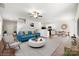 Bright living room flows into a dining area and kitchen with modern appliances and plenty of natural light at 7113 Amberly Hills Rd, Charlotte, NC 28215