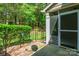 View of a screened in back porch with an opening to a well landscaped back yard at 749 Petersburg Dr, Fort Mill, SC 29708