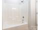 This bathroom features a shower and tub combination with white tile walls at 749 Petersburg Dr, Fort Mill, SC 29708
