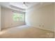Bright primary bedroom with large window and trey ceiling at 749 Petersburg Dr, Fort Mill, SC 29708