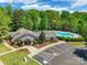 Aerial shot of the clubhouse, parking lot, and swimming pool surrounded by mature trees at 749 Petersburg Dr, Fort Mill, SC 29708
