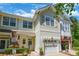Charming townhome showcasing an attached garage, well-maintained lawn, and beautiful curb appeal at 749 Petersburg Dr, Fort Mill, SC 29708