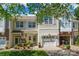 Inviting townhome featuring a one car garage, tidy landscaping, and a charming stone facade at 749 Petersburg Dr, Fort Mill, SC 29708
