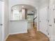 Open-concept foyer featuring wood floors, arched doorways, and staircase to the second floor at 749 Petersburg Dr, Fort Mill, SC 29708
