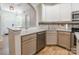 Updated kitchen featuring granite countertops, stainless steel appliances, and light wood floors at 749 Petersburg Dr, Fort Mill, SC 29708