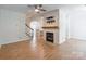 This living room has hardwood floors, a fireplace, and is open to the kitchen at 749 Petersburg Dr, Fort Mill, SC 29708