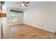 Living room features hardwood floors, a ceiling fan, and a window overlooking the backyard at 749 Petersburg Dr, Fort Mill, SC 29708