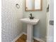 Charming half bathroom with pedestal sink and decorative wallpaper at 749 Petersburg Dr, Fort Mill, SC 29708