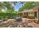 Charming brick patio with dining set, string lights, and lush greenery, offering a serene outdoor space at 751 Lansdowne Rd, Charlotte, NC 28270