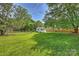 Spacious backyard with lush green grass, mature trees, and a quaint shed, creating a peaceful retreat at 751 Lansdowne Rd, Charlotte, NC 28270