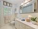 Bright bathroom featuring tiled walls, single sink vanity, and shuttered window at 751 Lansdowne Rd, Charlotte, NC 28270