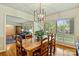 Bright dining room with hardwood floors and a view into the living room creating a great flow for entertaining at 751 Lansdowne Rd, Charlotte, NC 28270