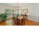 Elegant dining room features natural light from the large window and traditional wooden table and chairs at 751 Lansdowne Rd, Charlotte, NC 28270