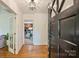 Inviting foyer showcasing gleaming hardwood floors, a stylish light fixture, and a glimpse into the home's interior at 751 Lansdowne Rd, Charlotte, NC 28270