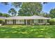 Charming brick ranch-style home with a well-manicured lawn and classic shutters at 751 Lansdowne Rd, Charlotte, NC 28270