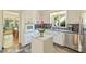 Functional kitchen featuring white cabinets, neutral backsplash, stainless steel appliances and a tiled floor at 751 Lansdowne Rd, Charlotte, NC 28270