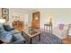 Comfortable living room with hardwood floors, view into dining room, a classic secretary, and a cozy blue sofa at 751 Lansdowne Rd, Charlotte, NC 28270