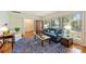 Open living room featuring hardwood floors, plantation shutters, and access to other parts of the house at 751 Lansdowne Rd, Charlotte, NC 28270