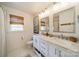 Bright bathroom featuring dual vanities, marble countertops, and modern fixtures at 8330 Fallsdale Dr, Charlotte, NC 28214