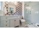 Beautiful bathroom with unique wallpaper and updated vanity with glass shower at 8330 Fallsdale Dr, Charlotte, NC 28214