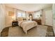Serene bedroom with neutral tones, plush bedding, and ample natural light from multiple windows at 8330 Fallsdale Dr, Charlotte, NC 28214
