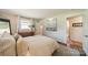 Relaxing bedroom with hardwood floors, neutral decor, and a view to the ensuite bathroom at 8330 Fallsdale Dr, Charlotte, NC 28214