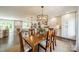 Open concept dining and kitchen area featuring hardwood floors, white cabinets, and natural light at 8330 Fallsdale Dr, Charlotte, NC 28214