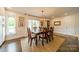 Bright dining room with hardwood floors, large windows, and a stylish light fixture at 8330 Fallsdale Dr, Charlotte, NC 28214