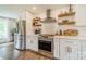 Modern kitchen with stainless steel appliances, open shelves, and ample counter space at 8330 Fallsdale Dr, Charlotte, NC 28214