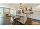 Stylish kitchen island with pendant lighting, seating, and modern stainless steel appliances at 8330 Fallsdale Dr, Charlotte, NC 28214