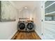 Convenient laundry room features modern washer and dryer units, as well as extra storage space at 8330 Fallsdale Dr, Charlotte, NC 28214