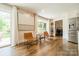 Inviting living room with hardwood floors, modern art, and access to the outdoor patio at 8330 Fallsdale Dr, Charlotte, NC 28214