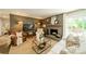 Comfortable living room with fireplace, TV, leather chair, and natural light at 8330 Fallsdale Dr, Charlotte, NC 28214
