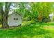 White-painted shed in backyard with decorative wreaths on doors at 8330 Fallsdale Dr, Charlotte, NC 28214