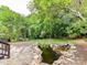 The backyard features a serene koi pond and a lush green lawn at 8921 Magnolia Heights Ct, Charlotte, NC 28270