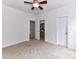 Bedroom with neutral carpet, ceiling fan, white trim, and bathroom entrance at 8921 Magnolia Heights Ct, Charlotte, NC 28270