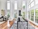 Elegant dining room with soaring windows, modern lighting, and stylish furnishings perfect for entertaining at 8921 Magnolia Heights Ct, Charlotte, NC 28270