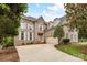 Stately brick home with mature landscaping and a well-maintained front lawn showcasing curb appeal at 8921 Magnolia Heights Ct, Charlotte, NC 28270
