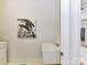 Laundry area with a utility sink, modern artwork and neutral-colored tile at 8921 Magnolia Heights Ct, Charlotte, NC 28270