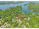 Aerial view of 9012 Windjammer Drive in waterfront community nestled among mature trees and a tranquil lake at 9012 Windjammer Dr, Tega Cay, SC 29708