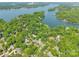 Breathtaking aerial view showcasing a waterfront community nestled among mature trees and a tranquil lake at 9012 Windjammer Dr, Tega Cay, SC 29708