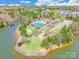 Aerial view of community pool, park and lake access with boat dock and surrounding homes at 9012 Windjammer Dr, Tega Cay, SC 29708